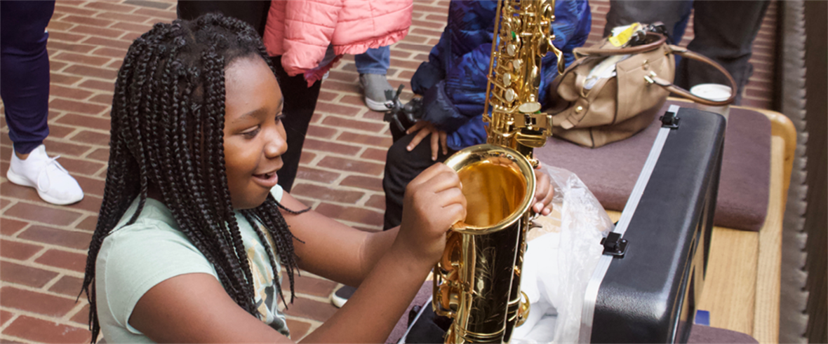 An LMP participant receives her new saxophone